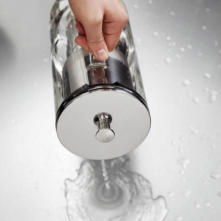 Someone emptys the water from the Aarke Purifier.