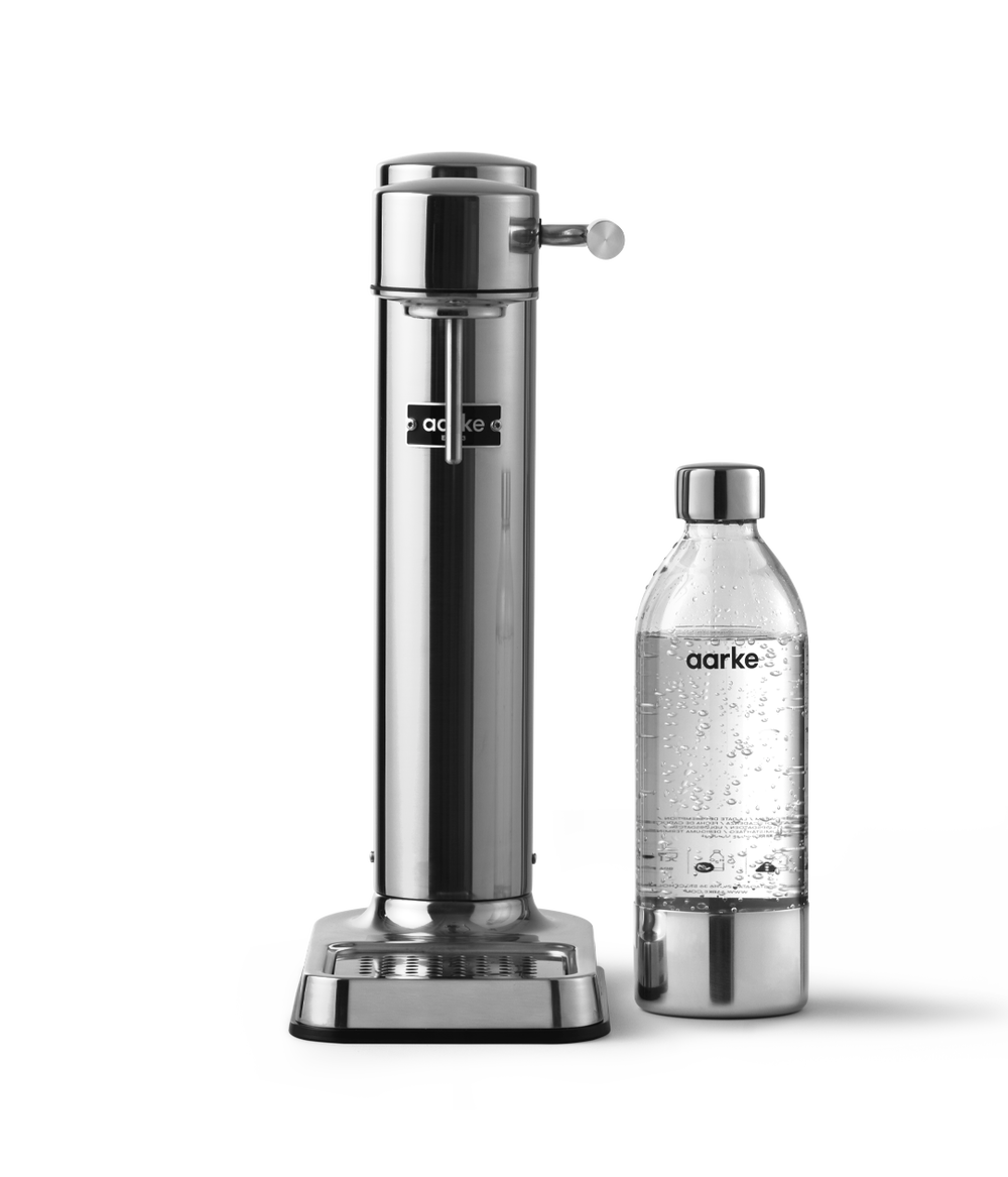 Aarke Carbonator 3 in Stainless Steel pictured beside a PET Bottle.
