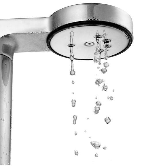 Close-up of Aarke sand-colored coffee maker shower head dispersing hot water for even pour-over extraction.
