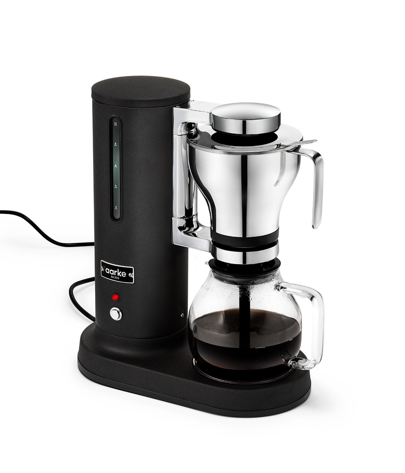 Aarke Coffee Maker Coffee with matte black base and glass carafe on a white background
