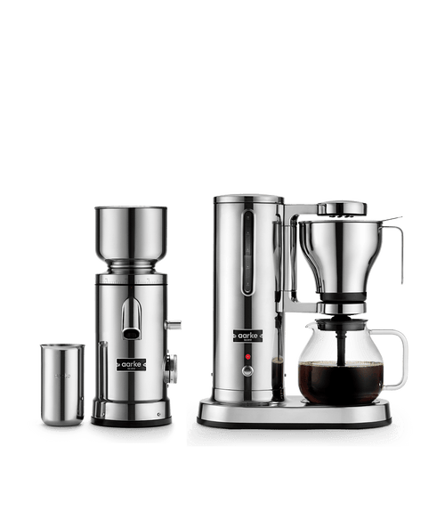 Aarke Coffee Maker and Coffee Grinder in Stainless Steel with stainless steel accessories and freshly brewed filter coffee.