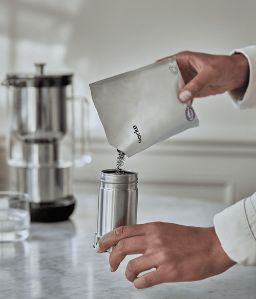 Adding Aarke Filter Granules to the Aarke Water Purifier filter cartridge in stainless steel.