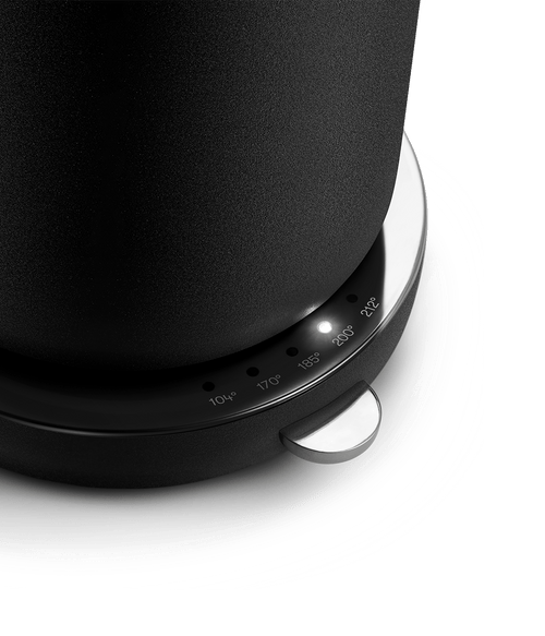 Close-up of Aarke Kettle in Matte Black with LED light indicating 200°F on the temperature selector.