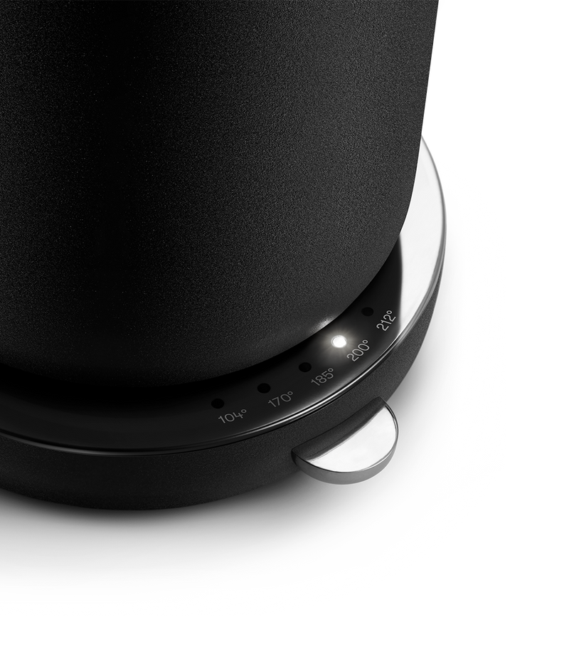 Close-up of Aarke Kettle in Matte Black with LED light indicating 200°F on the temperature selector.