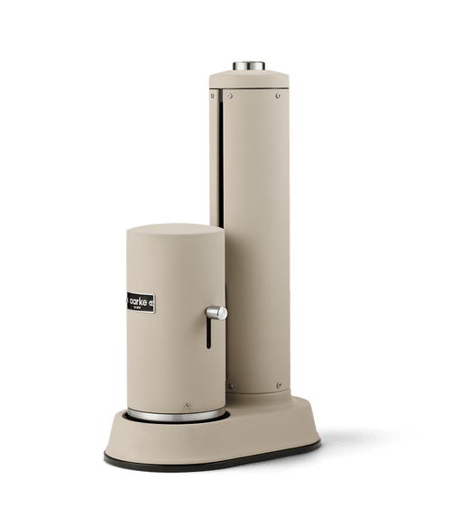 Side view of the Aarke Carbonator Pro Sand with the safety chamber cover closed and carbonation lever visible.