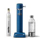 Front view of the Carbonator 3 in Cobalt Blue beside a PET water bottle and 1 Aarke CO2 Cylinder.