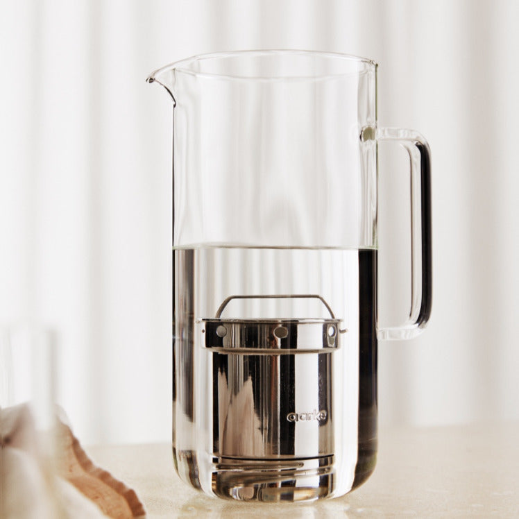 The Aarke Purifier filter sits inside of the Carafe soaking in water.