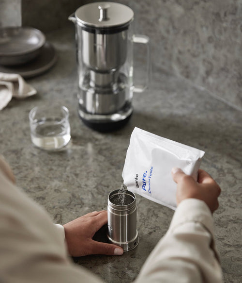 Pouring filter granules into the filter cartridge.