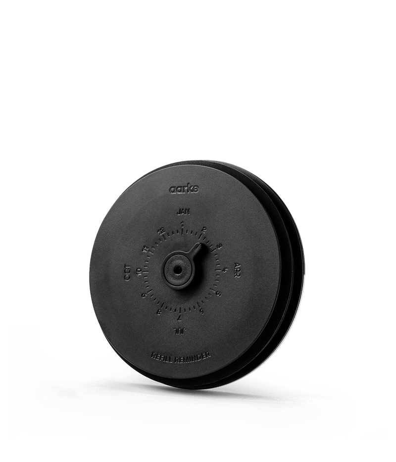 Close-up of Aarke Purifier Large black lid with adjustable refill reminder dial.