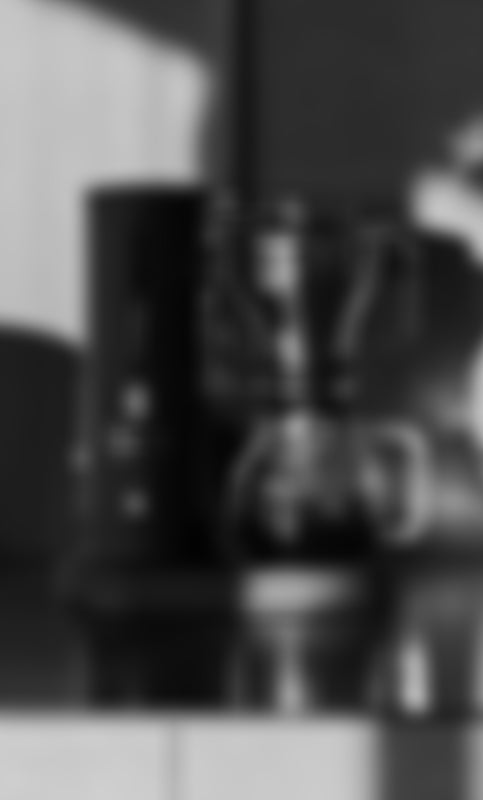 Black and white image of a the Aarke Coffee Maker Matte Black with a blurred background