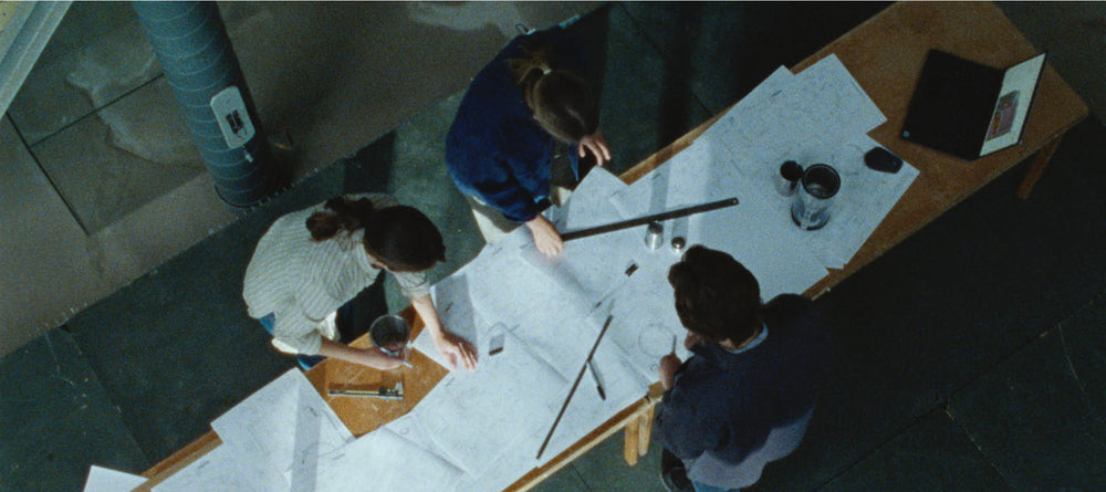 picture of the engineers at Aarke looking at drawings and desing-papers.