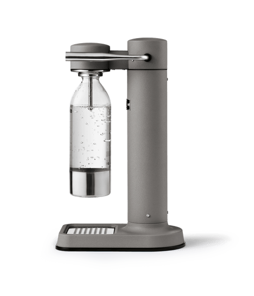 Side view of the Aarke Carbonator 3 in Matte grey with a carbonated bottle attached, bubbles visible inside.