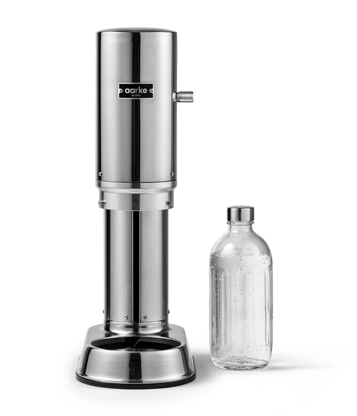 Front view of Aarke Carbonator Pro in Stainless Steel with chamber open and Aarke glass bottle next to it.