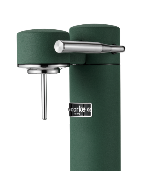 Close-up of the Aarke Carbonator 3 in Heritage Green showing its textured finish, stainless steel carbonation lever, and Aarke logo.