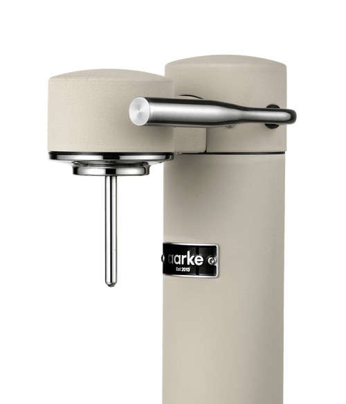 Close-up of the Aarke Carbonator 3 in Sand, highlighting the carbonation lever and nozzle.