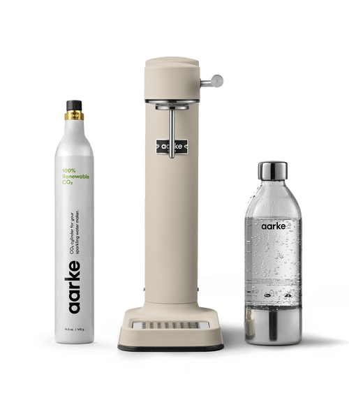 Front view of the Carbonator 3 in Sand beside a PET water bottle and a CO2 gas Cylinder.
