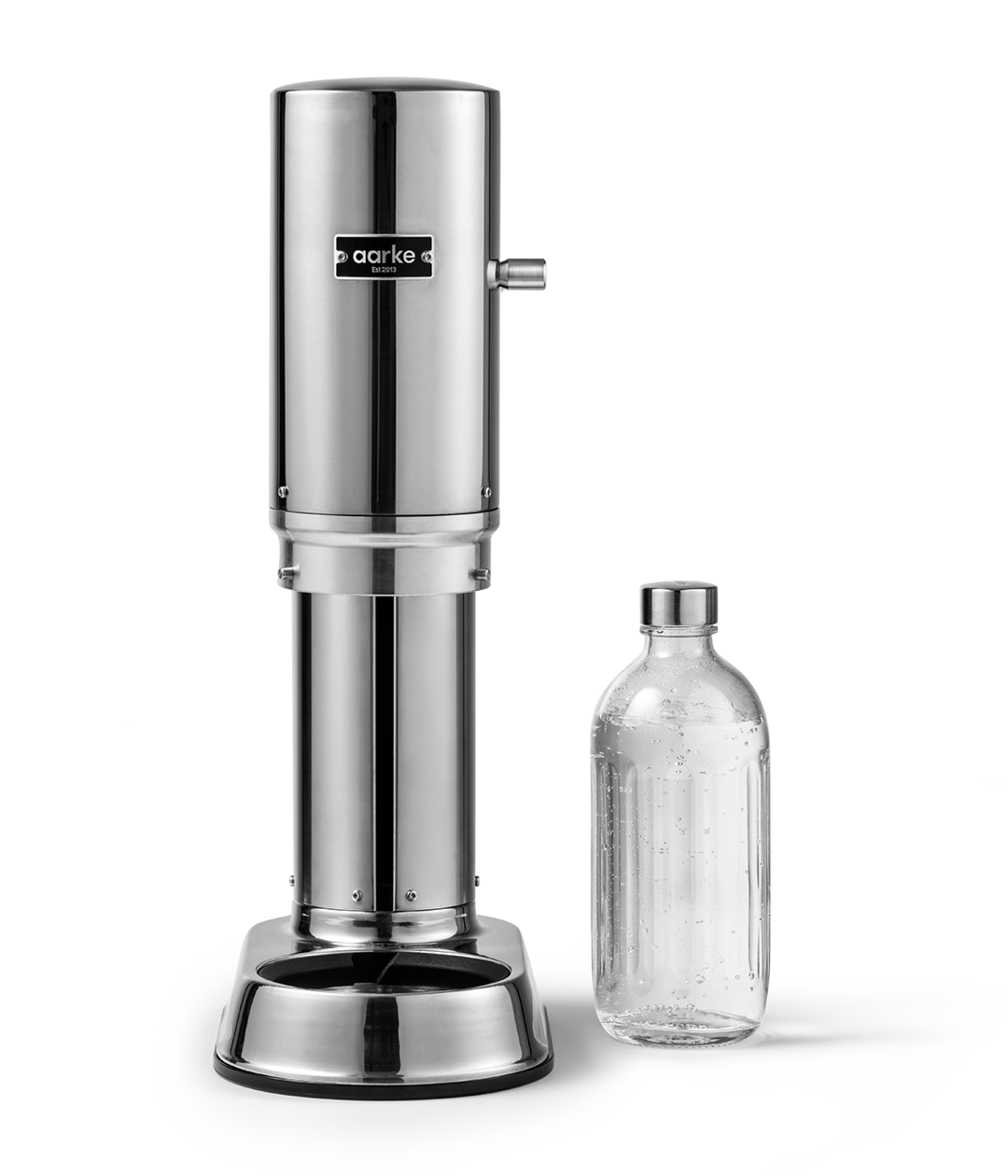 Aarke Carbonator Pro in Stainless Steel. Front view with chamber open and Glass Bottle sitting beside the Carbonator/