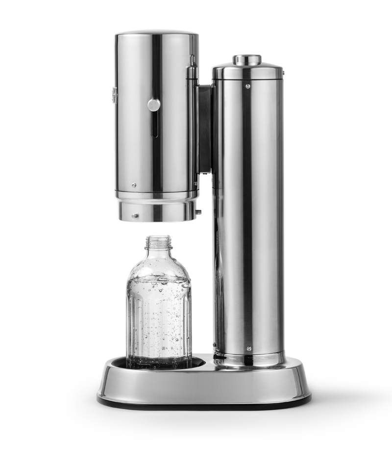 Aarke Carbonator Pro in Stainless Steel.Side view with chamber open and glass bottle sitting inside.