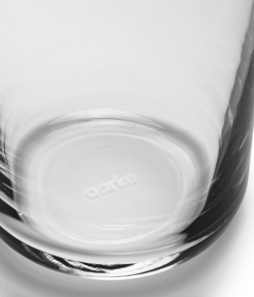 Close-up of the bottom of an Aarke glass, showing the Aarke logo inside the clear glass.